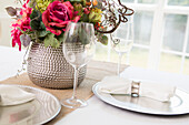 Elegant table setting at wedding event with plate charger and napkin