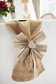 Burlap table runner and bow with elegant table setting