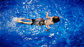 Boy Swimming in Pool