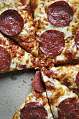 Overhead View of Sliced Pepperoni Pizza in Box, One Slice Missing