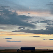 Transport truck at dusk on the Trans Canada Highway near Swift Current, Alberta, Canada