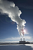 Industrial smoke stacks with steam billowing into blue sky, Toronto, Ontario, Canada