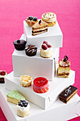 Variety of pastries and cakes on top of boxes, studio shot