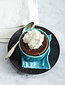 Dark Chocolate Souffles in ramekin on plate with sppon, studio shot