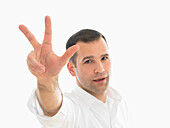 Portrait of Man Holding Up Three Fingers