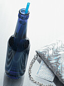 Bottle of Alcopop with Evening Bag, Studio Shot