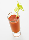 Glass of Bloody Mary with Celery Garnish on White Background, Studio Shot