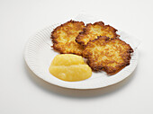 Potato Fritters with Applesauce on Paper Plate, Studio Shot