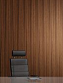 Illustration of office arm chair in front of wooden wall, tablet computer on glass table, studio shot