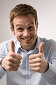 Portrait of Man Giving Thumbs Up