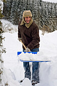 Man Shovelling Snow, Hof bei Salzburg, Austria