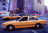 Blurred View of Taxis and Traffic On Street
