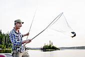 Man Fishing, Otter Lake, Missinipe, Saskatchewan, Canada