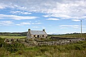 Isle Of Colonsay, Scotland; Stone Farmhouse, Fence And Surrounding Field