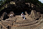 Tourist On Temple Stairs In Ancient City Of Angkor; Angkor Wat, Siem Reap, Cambodia