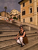 Female Tourist Sitting N The Step On Spanish Square And Smiling; Rome, Italy