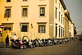 Row Of Motor Scooters Parked In Florence; Italy