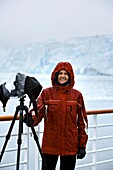 Hubbard Glacier, Alaska, Usa; Female Photographer Shooting Glacier From Boat