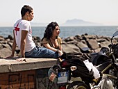 Mid-Adult Couple Sitting On Promenade; Naples, Italy