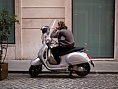 Man On The Phone Sitting In Scooter; Rome, Italy