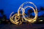 Three Fire-Twirlers Performing