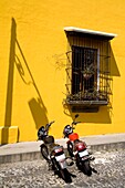 Antigua, Guatemala, Central America; Motorcycles Parked Outside Restaurant