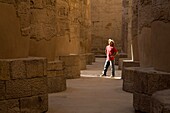 Man Standing In The Temple Of Karnak; Luxor,Egypt