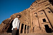 Man Standing By Royal Tomb In Petra