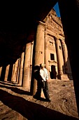Man Standing By Royal Tomb In Petra