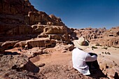 Man Sitting Near Monumental Nabataean Tombs