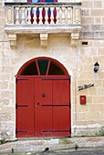 A Red Door On A Stone Building