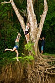 Children Swinging Over River, La Fortuna, Alajuela, Costa Rica