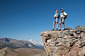 Couple Standing On The Top Of A Mountain; Jasper National Park,Alberta,Canada