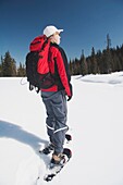 Woman In Snowshoes In The Snow