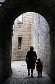 Woman With Child In Old Town Alley