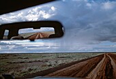 Dirt Road Reflected In Rear View Mirror