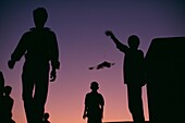 Silhouettes Of People Flying Kites
