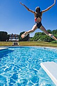 Girl Diving Into A Swimming Pool.