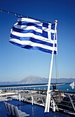 Greek Flag On A Ferry Leaving Port