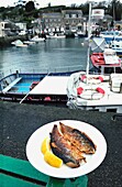 Kippers On A Plate On The Quayside In Padstow Harbour