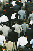 Crowds Of Businessmen Walking On The Streets Of Tokyo