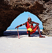 Samburu Tribesman Under Stone Arch On Diani Beach