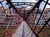 People Walking Across Bridge Over The Riu Onyar