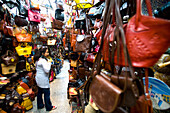 Female Tourist Buying A Leather Bag In Souq