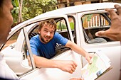 Backpacker Negotiating With Taxi Driver