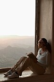 Female Traveller Reading In Window