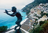 Bronze Of Pan Above Town With Ocean