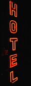 Red Neon Sign Saying Hotel