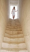 Woman Standing At Top Of Stairs