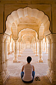 Tourist Sitting In Columned Hallway, Amber Fort